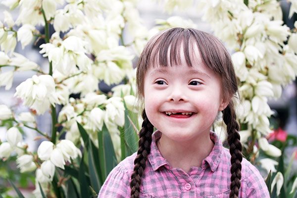 Portrait of beautiful young girl on flowers background.